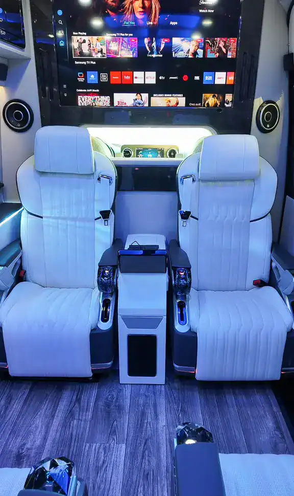 Seats and TV screen inside the MUSAT Mercedes-Benz Sprinter Jet for New Jersey limo service