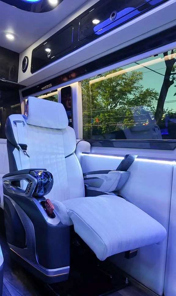 Relaxing white seat inside the MUSAT Mercedes-Benz Sprinter Jet, available for Brooklyn limo service